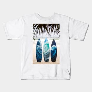 Surf boards with painted ocean waves on the beach with trees Kids T-Shirt